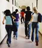 Teens running school hallway 