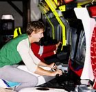 Teenage guy riding motobike in arcade 