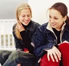 Teenage girls sitting laughing sidebar