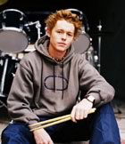 Teen drummer sitting with sticks 