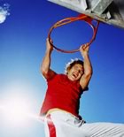 Basketball playing grabbing hoop 