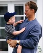 Father and toddler outside house