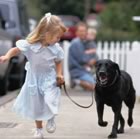 Young girl running with dog 