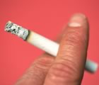 cigarette burning in a hand