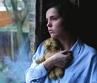 Woman at window looking sad