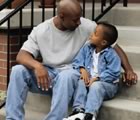 Father and young son talking on steps