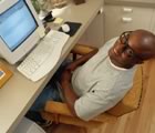 Guy at computer looking up
