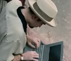 Hip dude with laptop and porkpie hat
