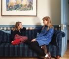 Mother and daughter chatting on couch