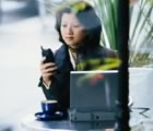 Woman with cellphone and laptop