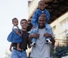 Young family walking down street
