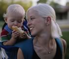 Young mother with child in backpack