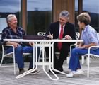 Couple talking outside with businessman