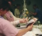 Nurses checking notes at station