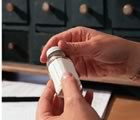 Hands holding pill bottle