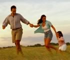 Family running in a field