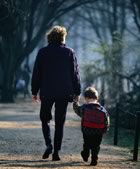 Mother and child walking along path