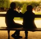 Pair silhouetted on bench