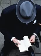  Overhead shot man in hat reading a book