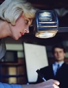 Woman making notes on projector