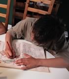 Boy colouring at kitchen table