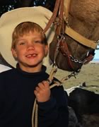 Boy with horse wearing cowboy hat