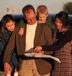 Family reading map outiside