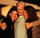 Father hugging older daughters