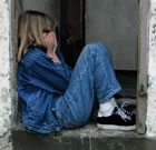 Girl in doorway with face covered