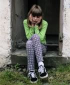 Sad girl sitting in doorway
